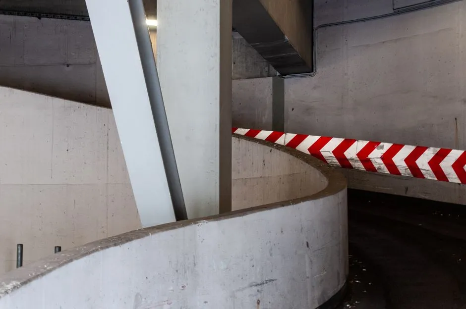 Interior of a modern multi-level parking garage structure, illustrative of the off-street facility types indexed on ParkSpotter